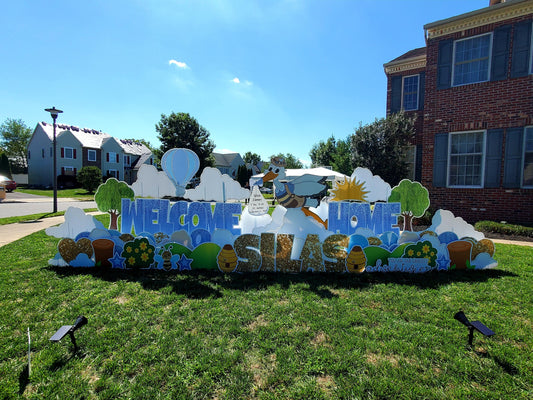 Baby boy stork rental with blue Welcome Home yard sign display
